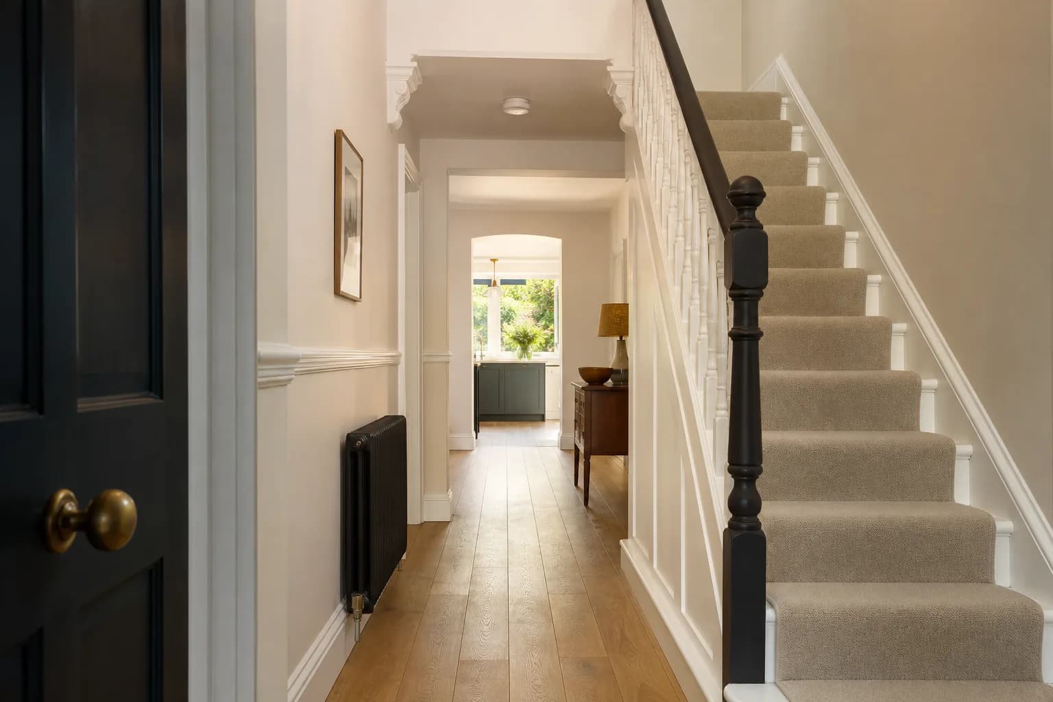 Freshly maintained interior hallway of a home with restored woodwork and newly painted walls